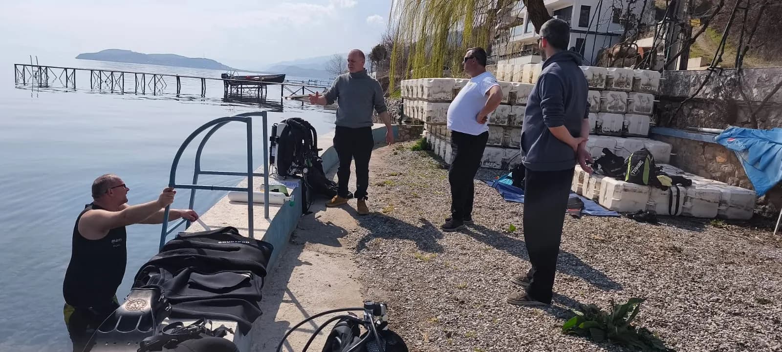 The Amphibia team preparing scuba diving gear on the shore before the cleanup action