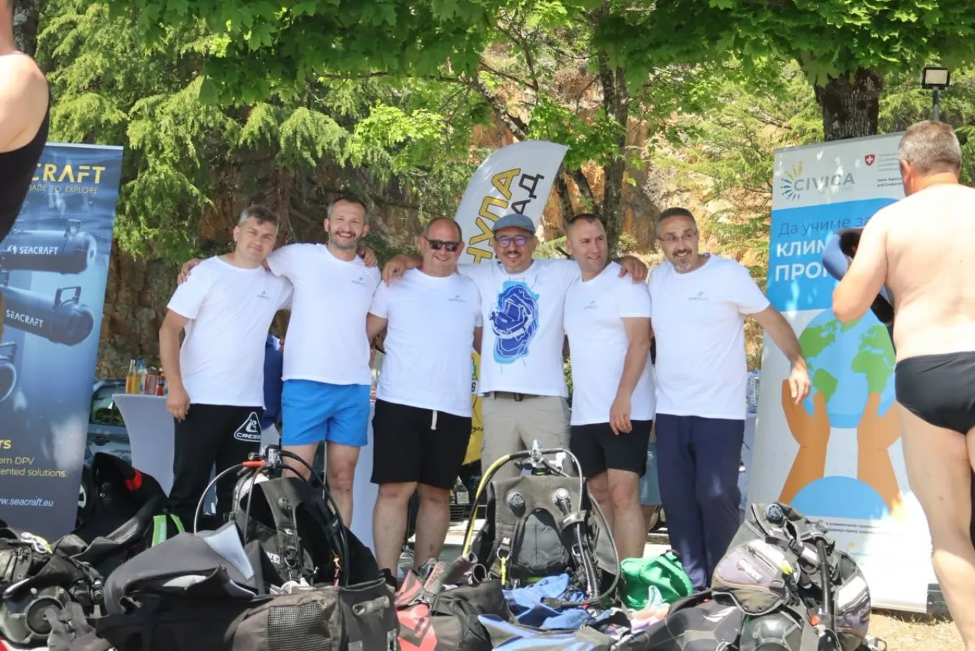 Group photo of the Amphibia team in white T-shirts before the start of the cleanup action