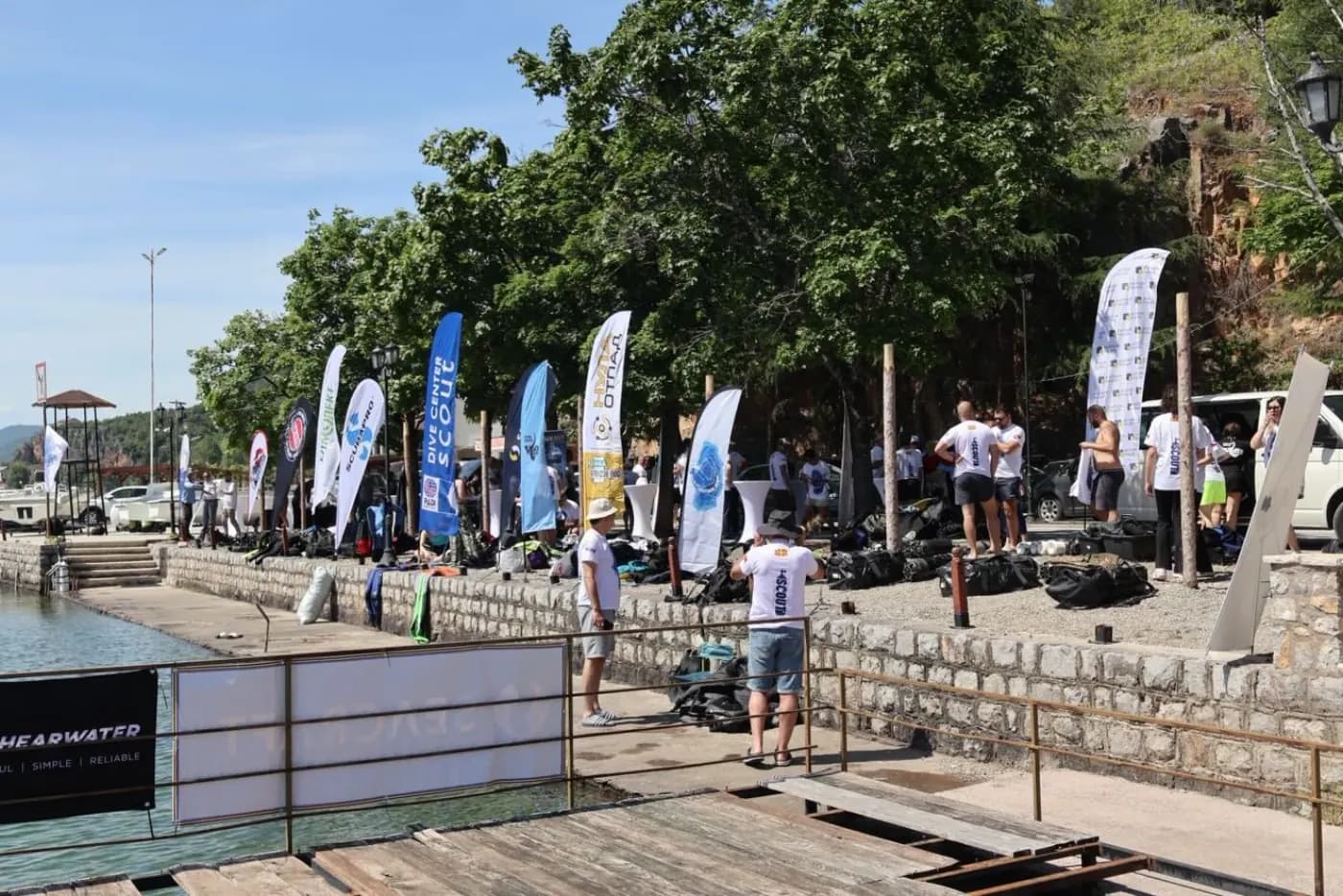 Wide view of Biser beach with the flags of partner diving clubs at the Lake Ohrid cleanup
