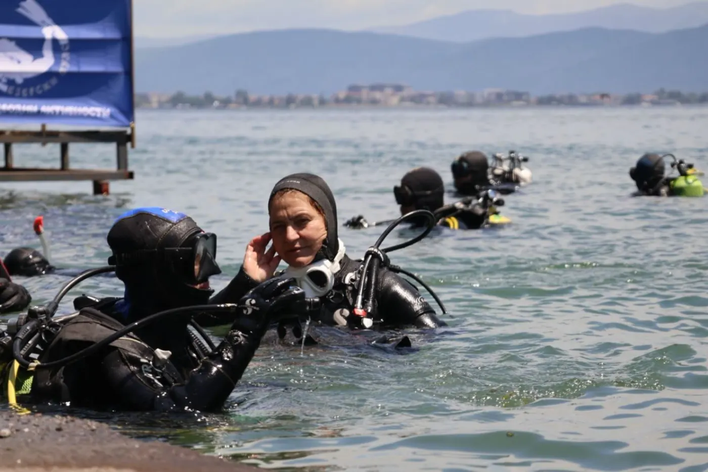 Scuba divers in the water before starting the dive in Lake Ohrid