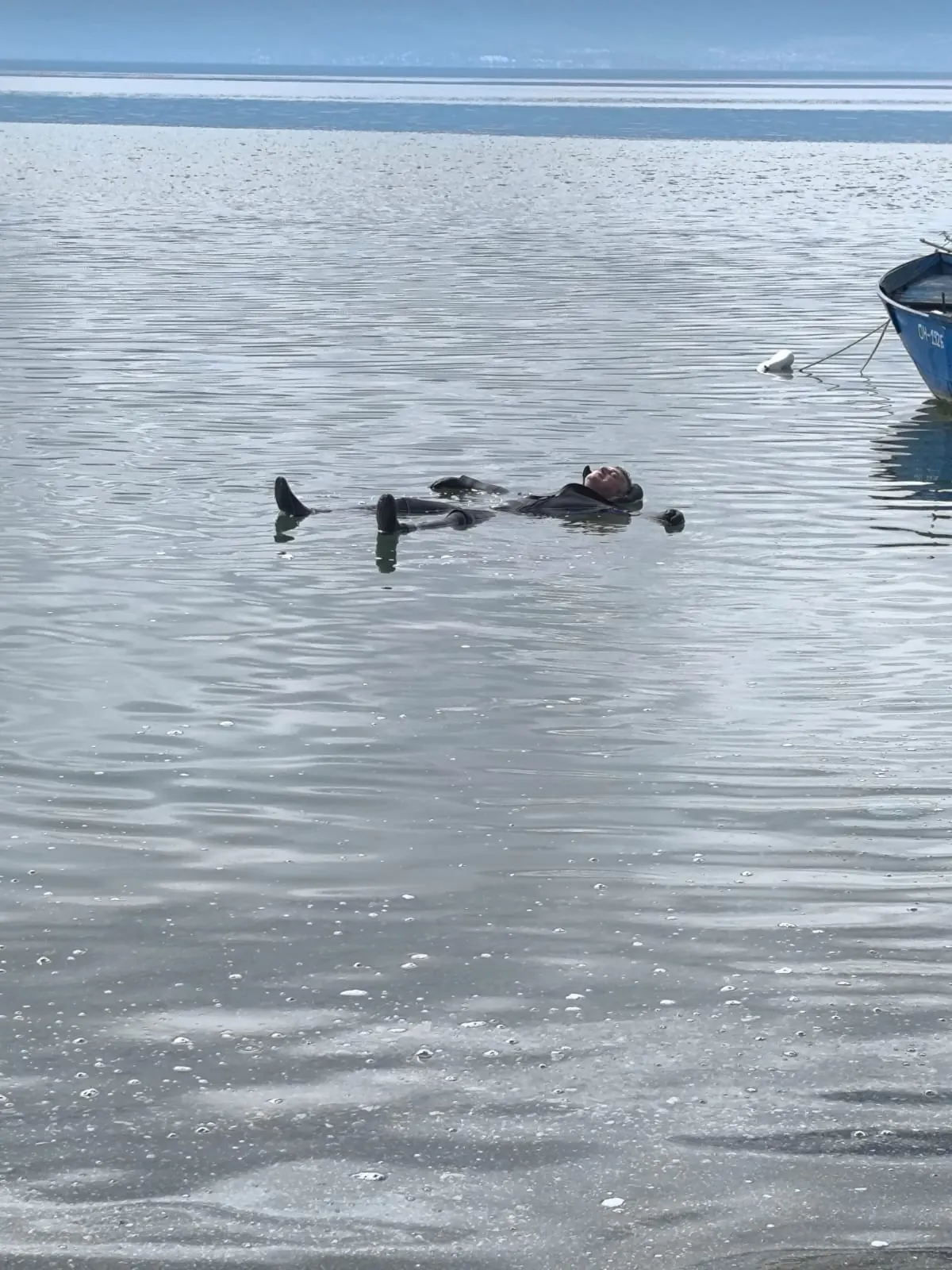 Amphibia team member floating relaxed on his back in Lake Ohrid after the dive