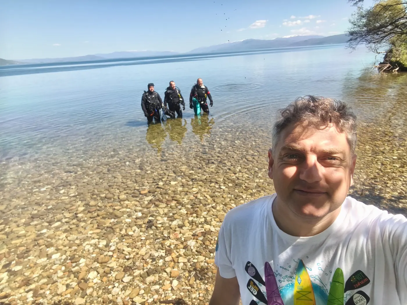Amphibia divers emerging from the clear water at Ljubaništa cove on Lake Ohrid