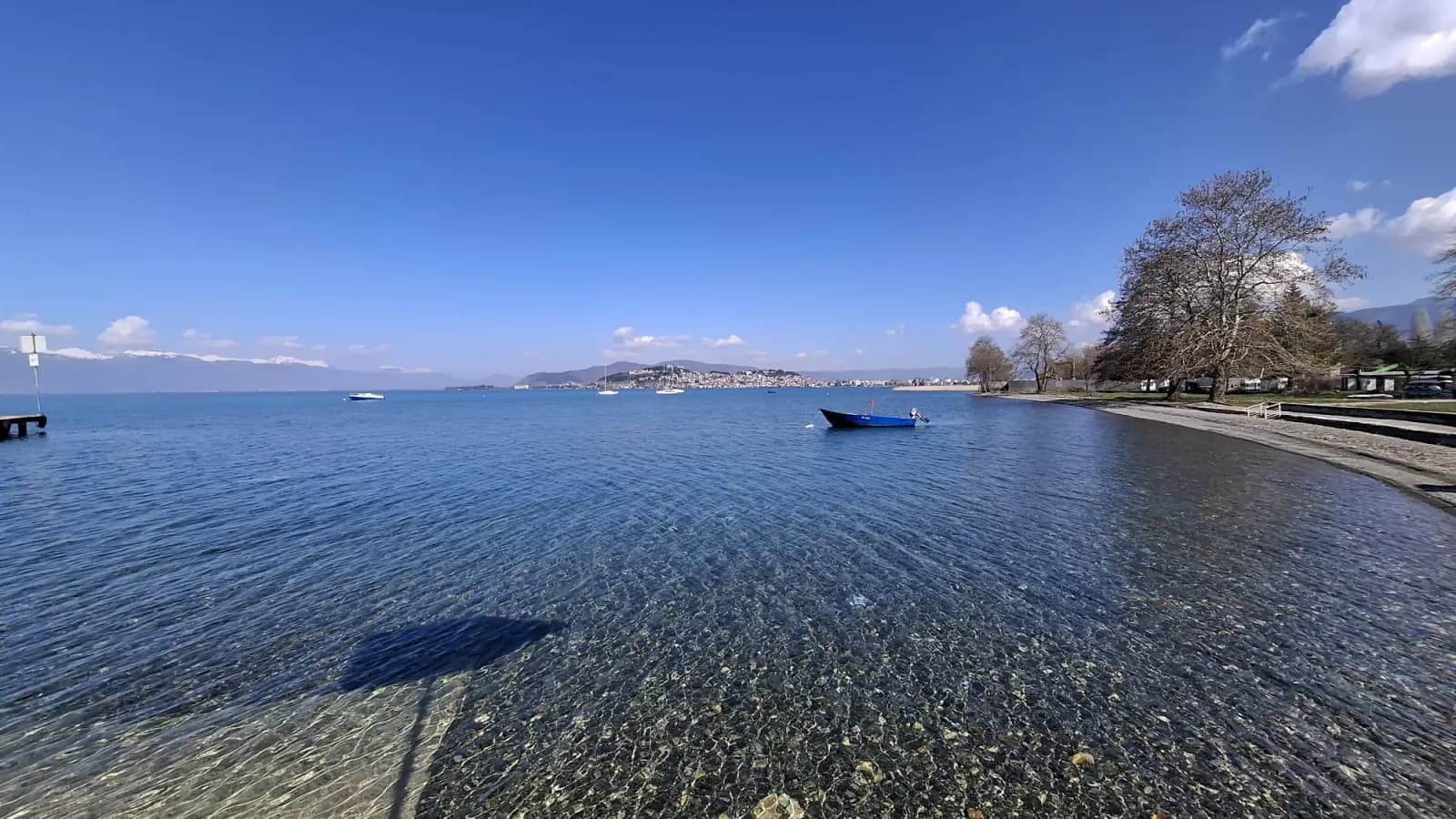 Panoramic view of Lake Ohrid from the shoreline, with the Old Town of Ohrid in the distance